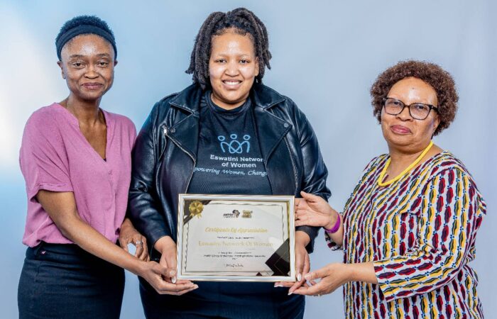 Eswatini NOW Deputy Chairperson (Youth Empowerment), Lindelwa Makhanya receiving the certificate(), she is flanked by AWPDF Chairperson Tizi Maphalala(r) and Technical Officer Lomcebo Dlamini (left)