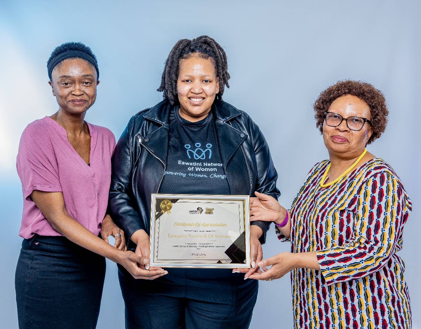 Eswatini NOW Deputy Chairperson (Youth Empowerment), Lindelwa Makhanya receiving the certificate(), she is flanked by AWPDF Chairperson Tizi Maphalala(r) and Technical Officer Lomcebo Dlamini (left)